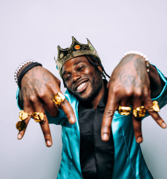 portrait of an hip hop music musician. Cinematic image of a man wearing party clothes and jewels